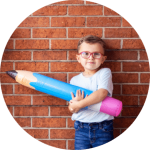 Child holding a large pencil, representing learning and ABA therapy resources from ABLE Kids.
