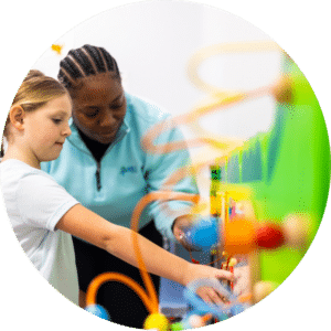 ABLE Kids therapist supporting a child during a play-based ABA therapy activity.